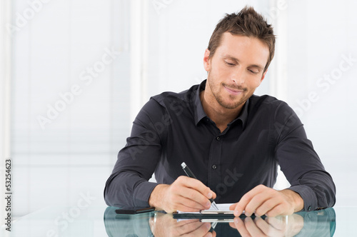 Businessman Writing Document photo