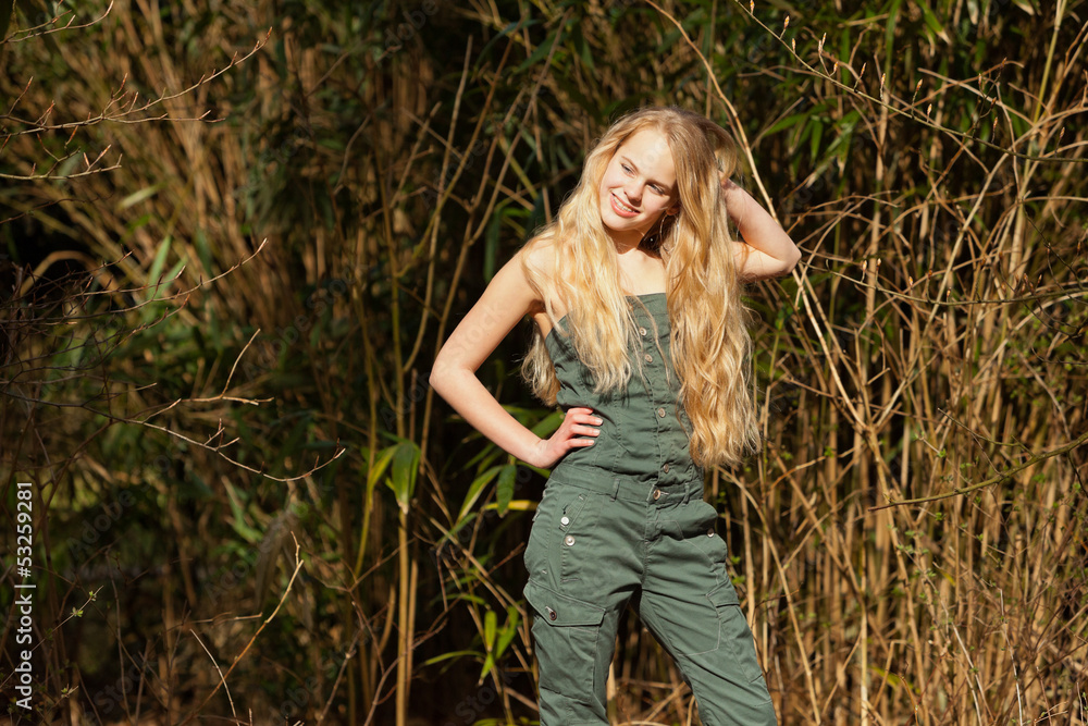 Funny happy young blonde girl in green park. Funny happy young blonde girl in green park.