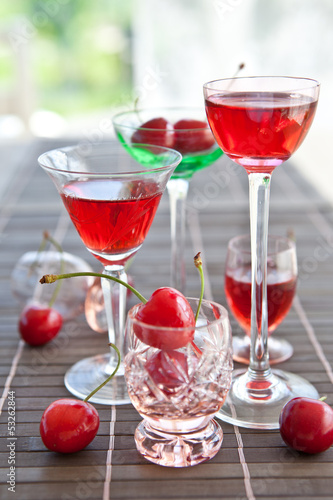 Various little glasses with cherry liquor photo