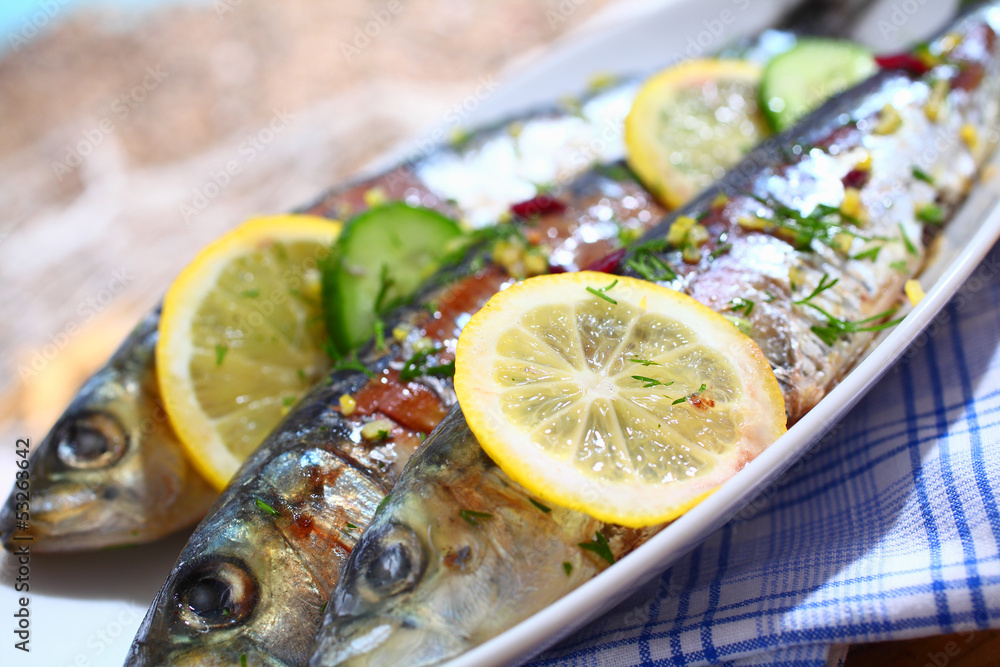 Close-up of grilled sardines on a platter outdoors Close-up of grilled sardines on a platter outdoors