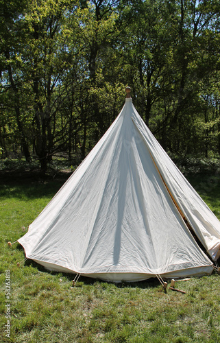A Round Vintage White Tent in a Woodland Clearing.