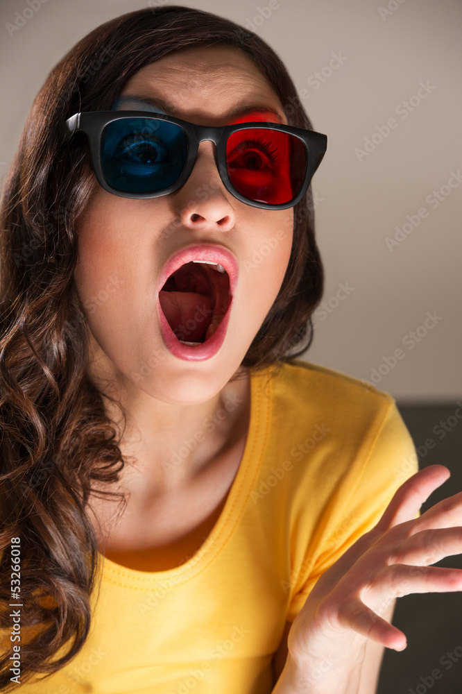 Expressive young woman watching 3d film