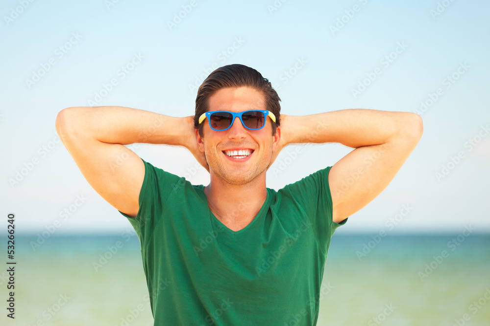 Handsome young man at beach background Handsome young man at beach background