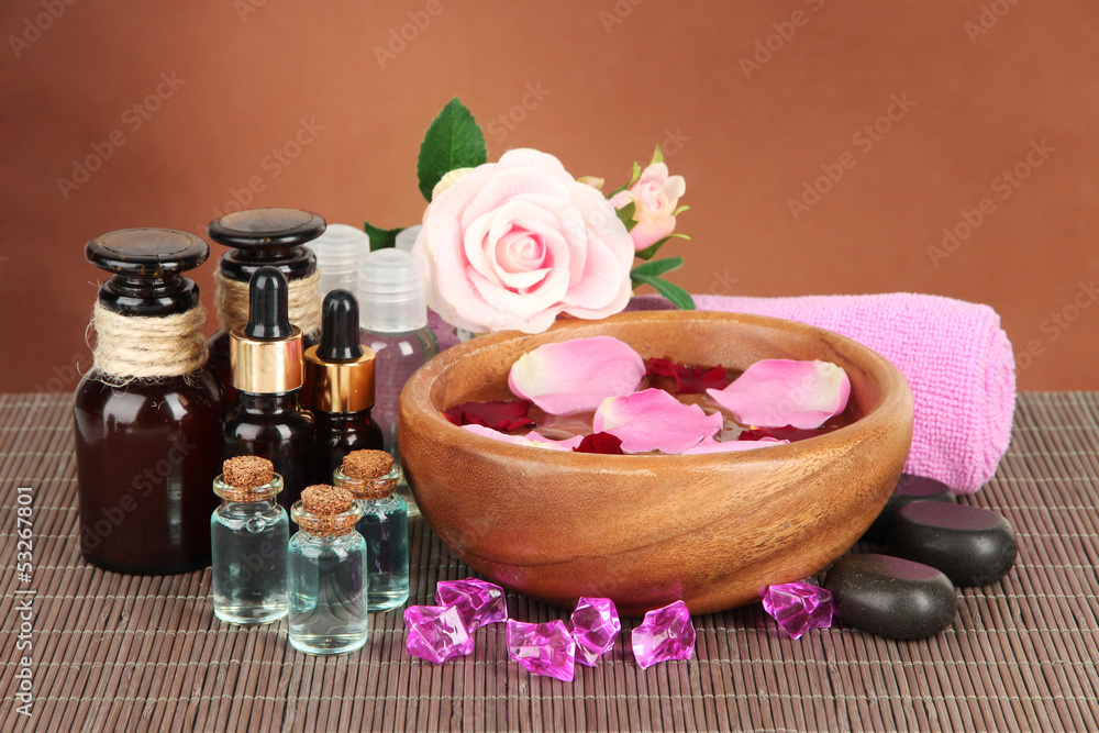Spa composition with aroma oils on brown background Spa composition with aroma oils on brown background
