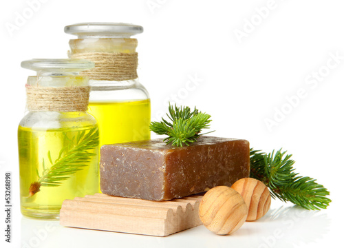 Hand-made soap and bottles of fir tree oil, isolated on white
