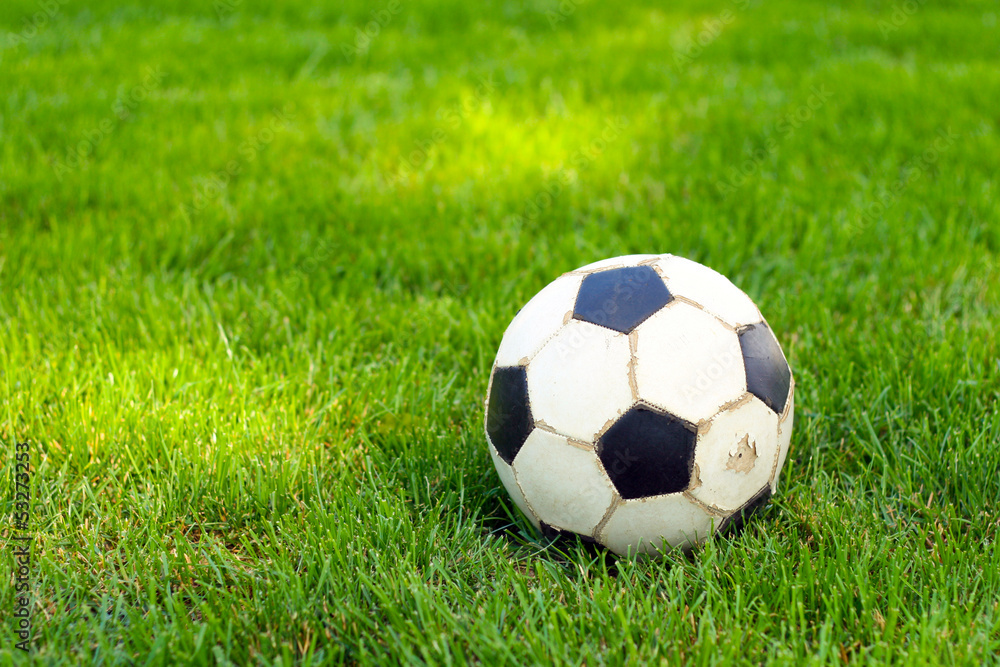 old football, soccer ball on the grass old football, soccer ball on the grass