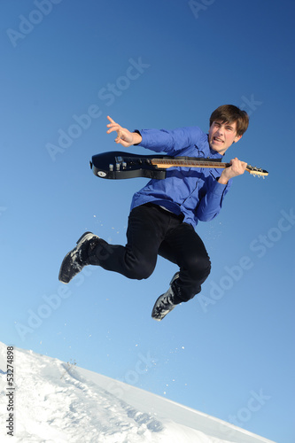 man with guitar jumping