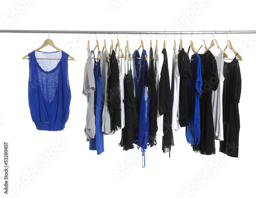 Variety of casual fashion shirt clothing on hangers and boots