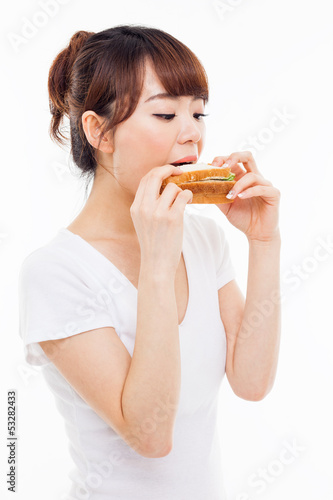 Young Asian woman eat sandwhich.