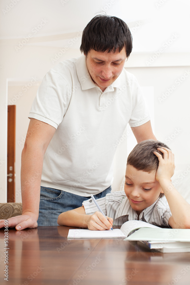 Father helping son do homework Father helping son do homework