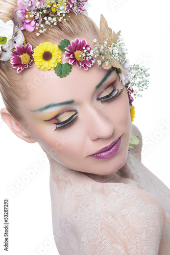 beauty woman with exptic make up looks down photo