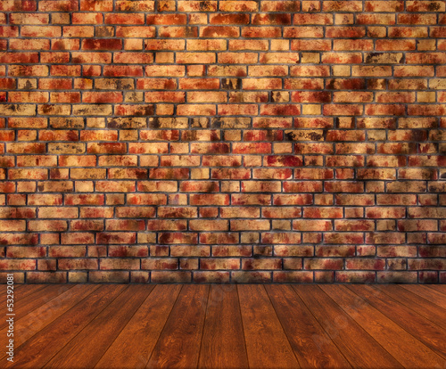 Wooden floor with brick wall