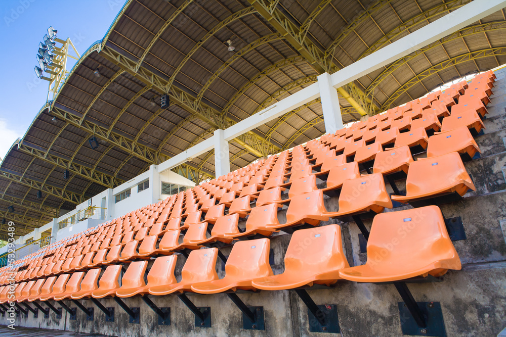 Obraz premium Stadium Orange Chair with roof and blue sky