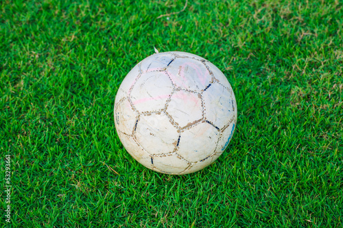 Old ball on beautiful green grass, sport