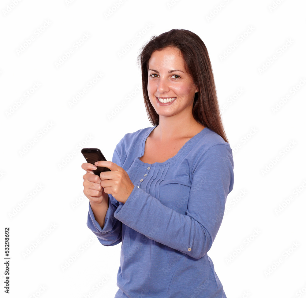 Lovely lady texting on cellphone while smiling Lovely lady texting on cellphone while smiling