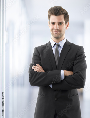 Business man smiling with arms crossed