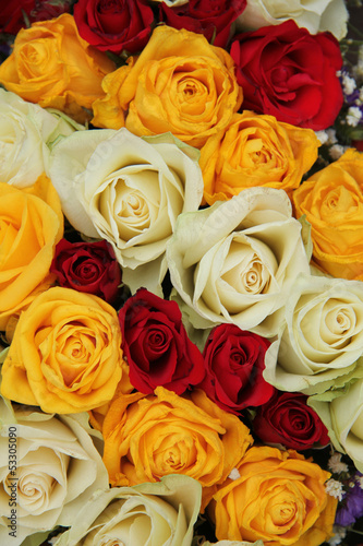 Yellow  white and red roses in a wedding arrangement