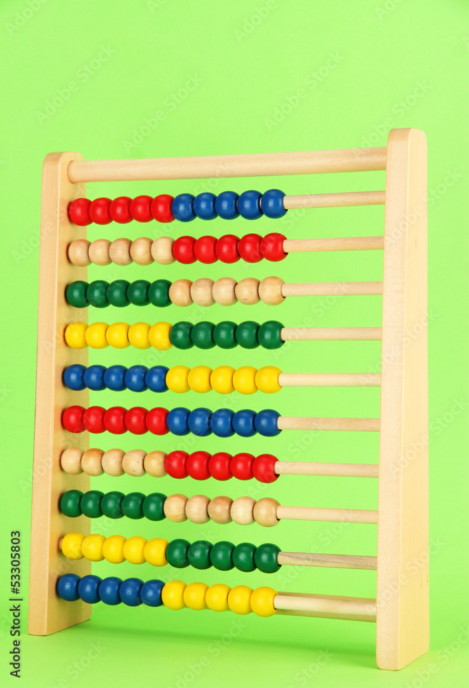 Bright wooden toy abacus, on green background Bright wooden toy abacus, on green background