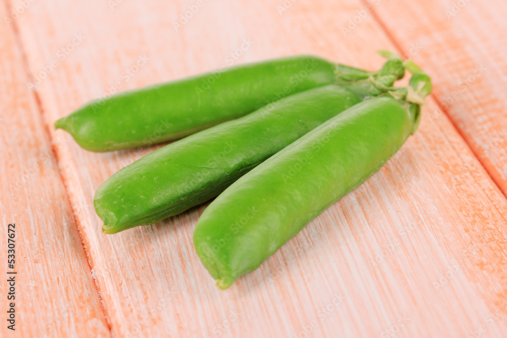 Sweet green peas on wooden background Sweet green peas on wooden background