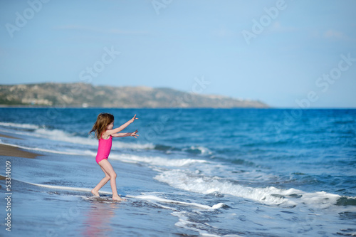 Adorable little girl on a sandy beach