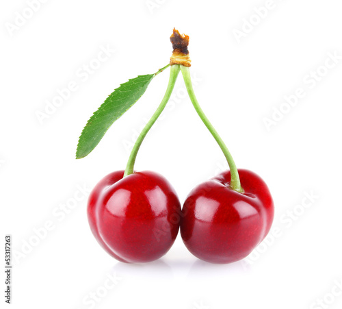 ripe juicy cherry with drop dew and green leaves