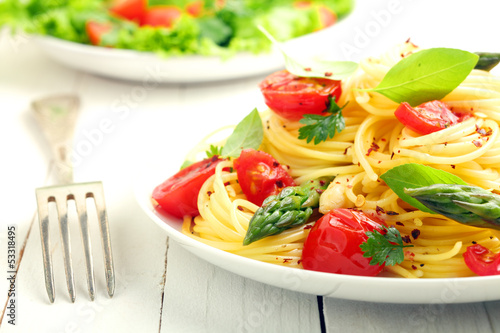 Coiled spaghetti with tomato and basil photo