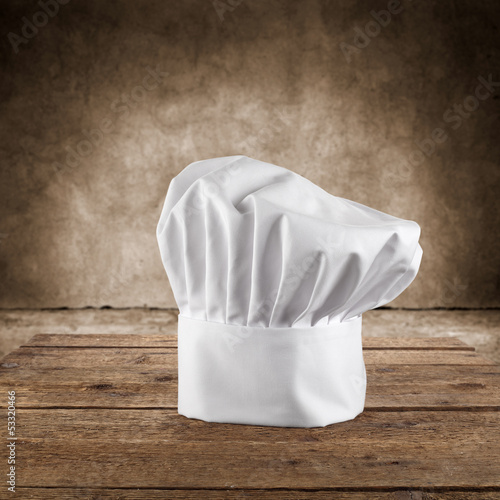 white cook cap and wooden table