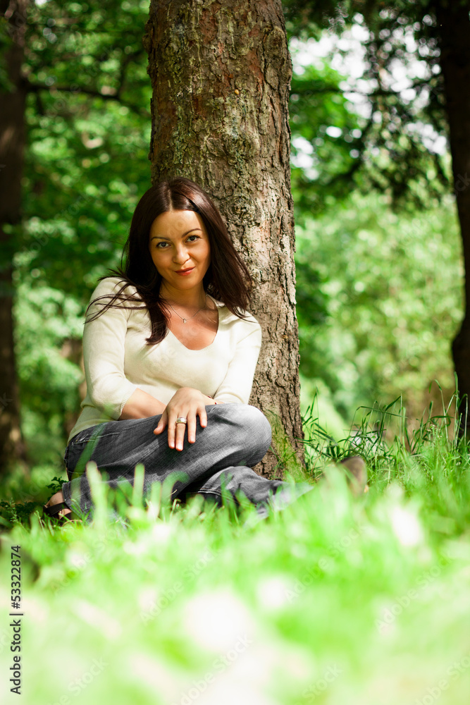portrait of young brunette in the summer garden portrait of young brunette in the summer garden