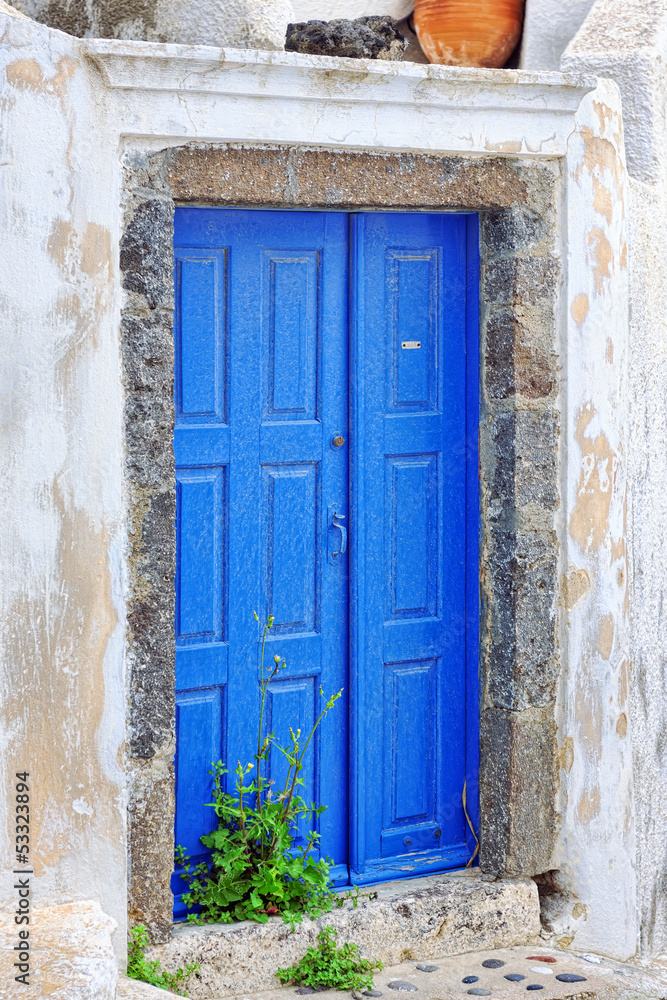 Blue traditional door of abandoned house in Pyrgos