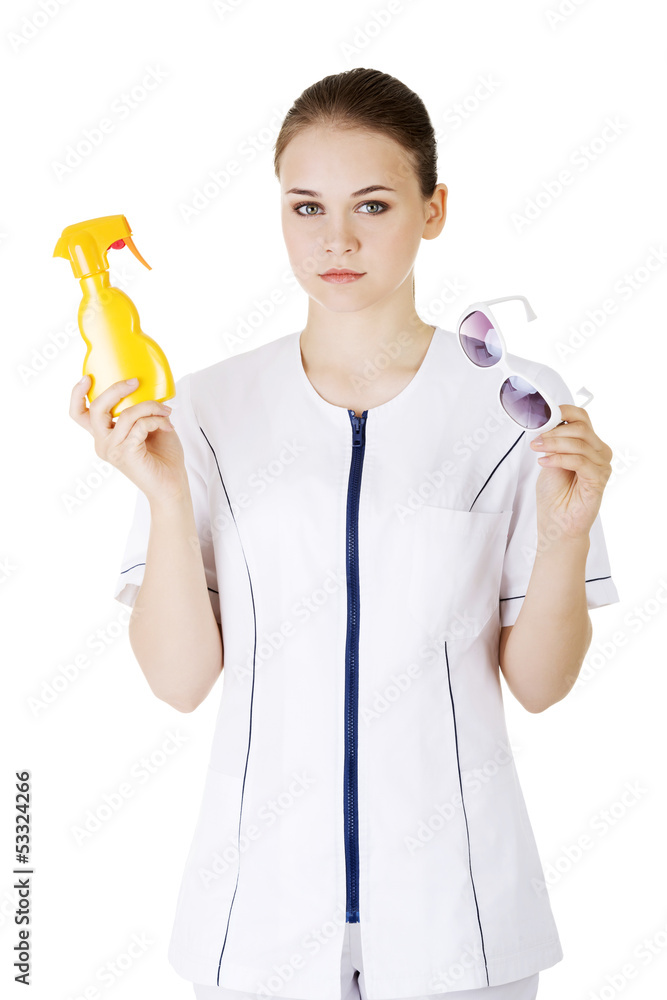Doctor or nurse showing sunscreen and sun glasses Doctor or nurse showing sunscreen and sun glasses