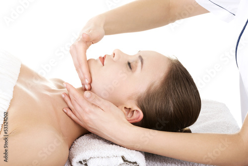 Relaxed woman enjoy receiving face massage at spa saloon