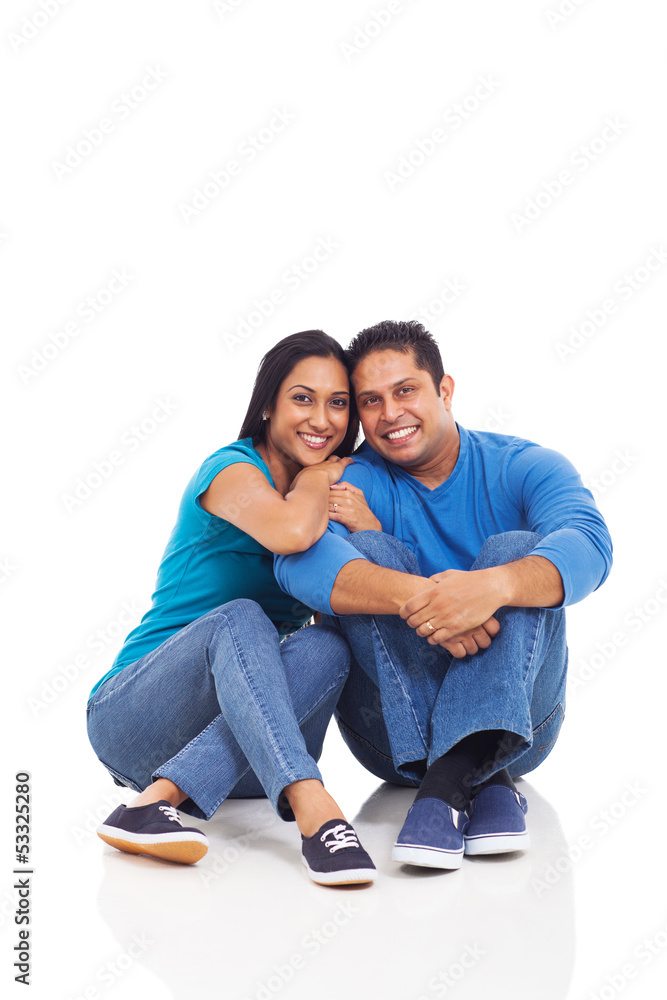 cute young indian couple sitting on the floor cute young indian couple sitting on the floor