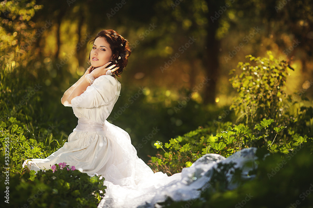 Gorgeous brunette beauty in a old-fashioned dress in a forest Gorgeous brunette beauty in a old-fashioned dress in a forest
