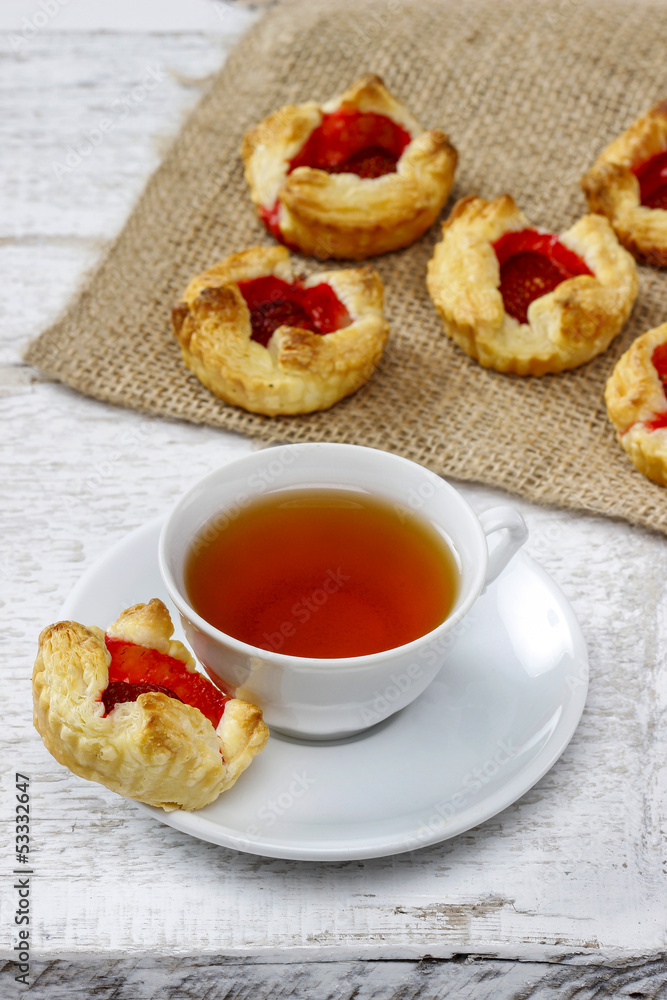 Cup of tea and small cakes on wooden rustic table Cup of tea and small cakes on wooden rustic table