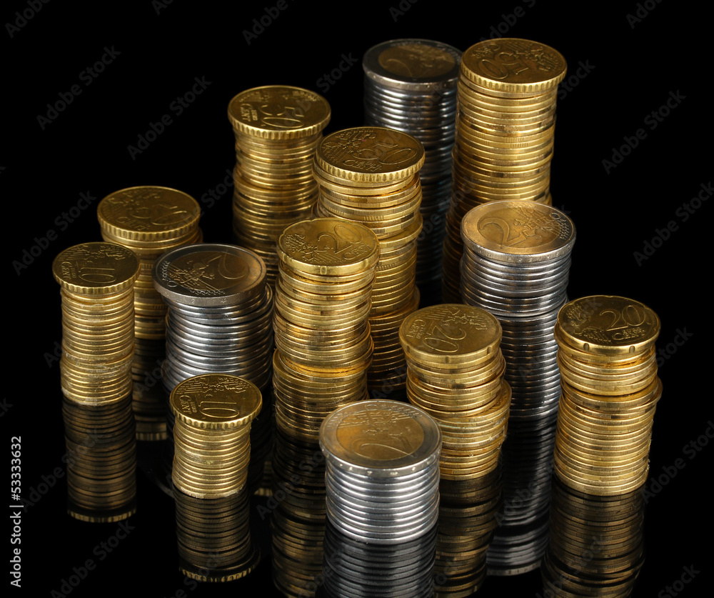 Many coins in columns isolated on black Many coins in columns isolated on black