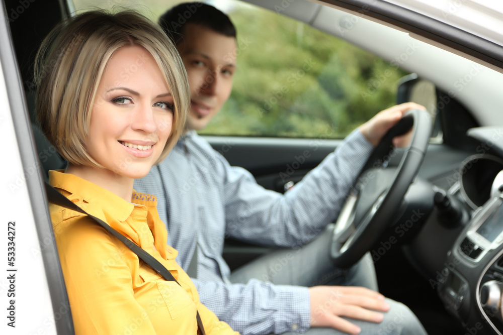 Portrait of young beautiful couple sitting in the car Portrait of young beautiful couple sitting in the car