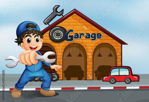 A happy boy in front of a garage