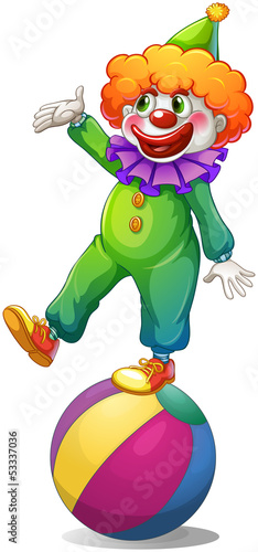 A clown standing above the ball