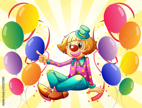 A female clown sitting surrounded with colorful balloons