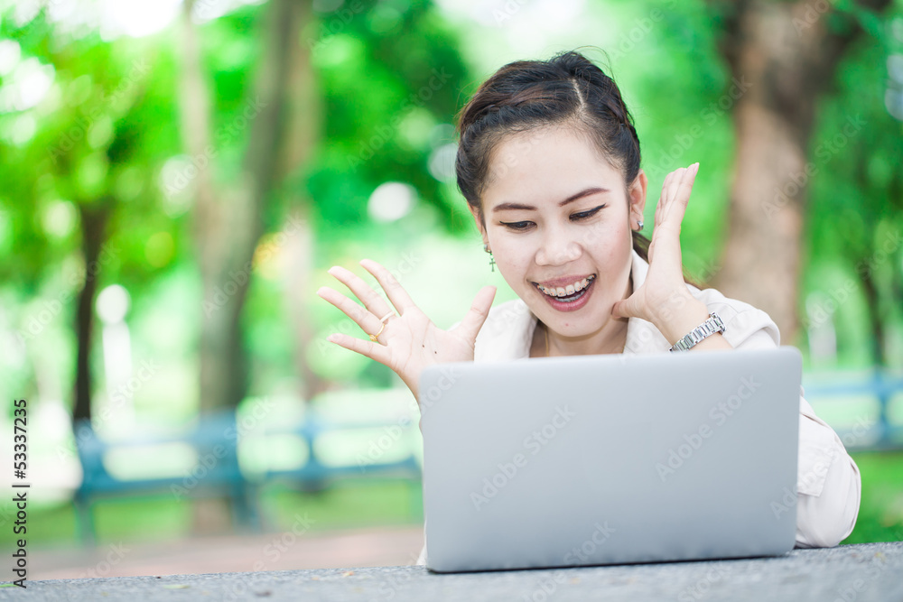 Surprised asian girl with laptop. Working on Computer, outdoor Surprised asian girl with laptop. Working on Computer, outdoor