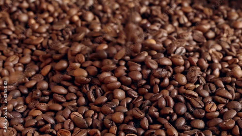 Roasted coffee beans falling from the top. Roasted coffee beans falling from the top.