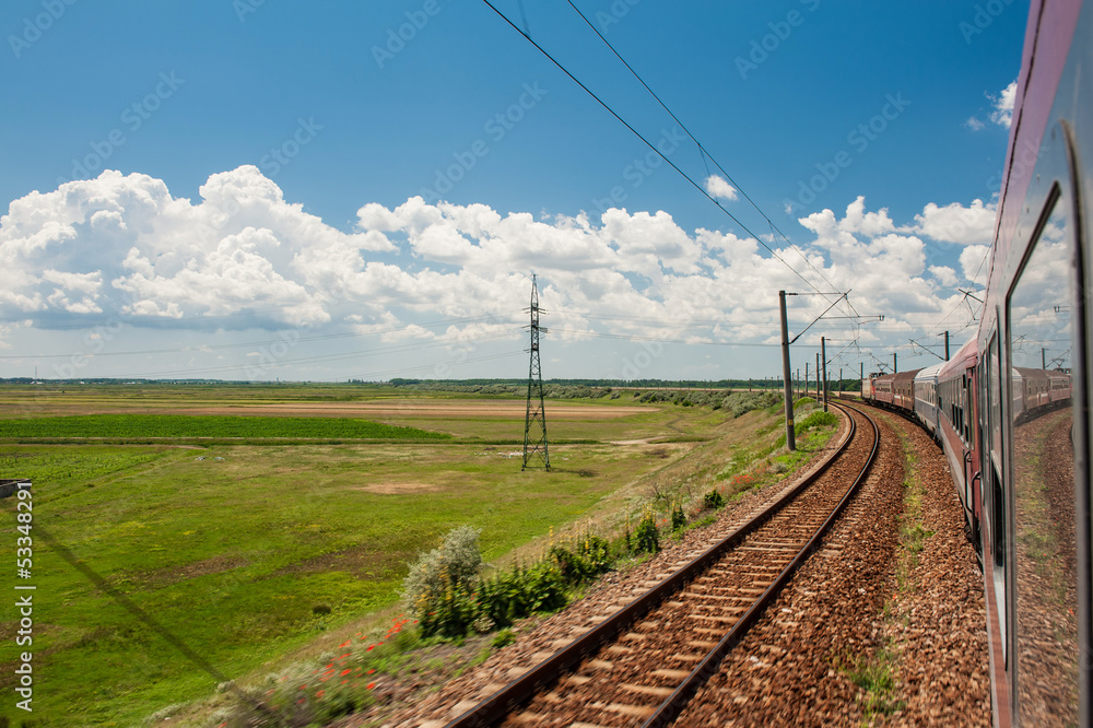 Scenic railroad in rural area and blue sky with white clouds