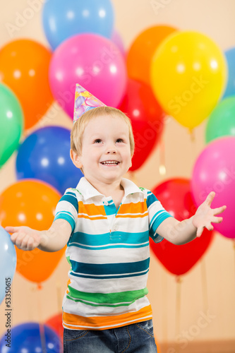 smiling child boy with balloons on birthday party