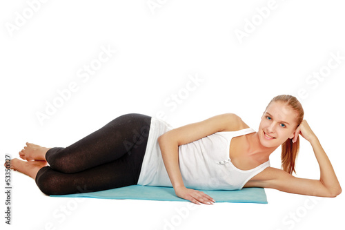 A sportive young woman lying on the floor