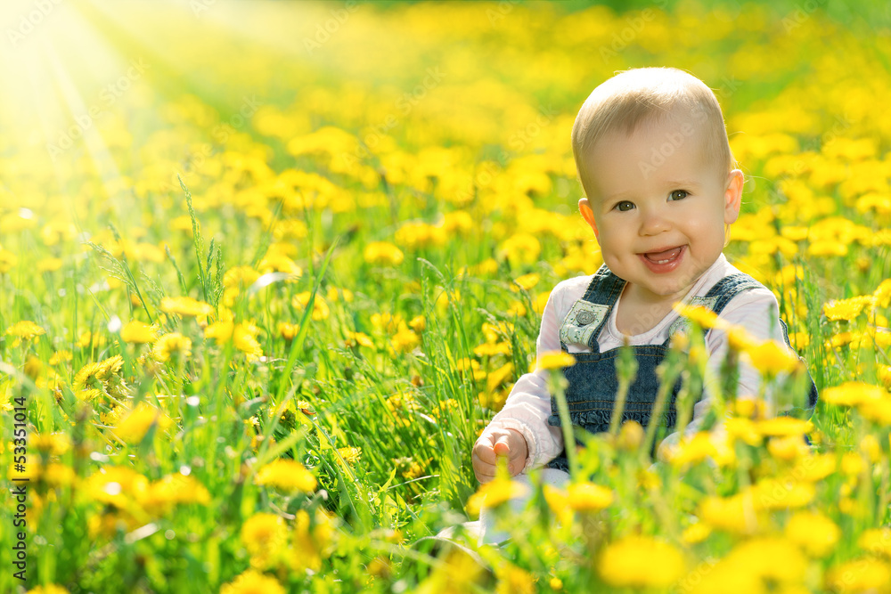 happy baby girl on meadow with yellow flowers on the nature happy baby girl on meadow with yellow flowers on the nature