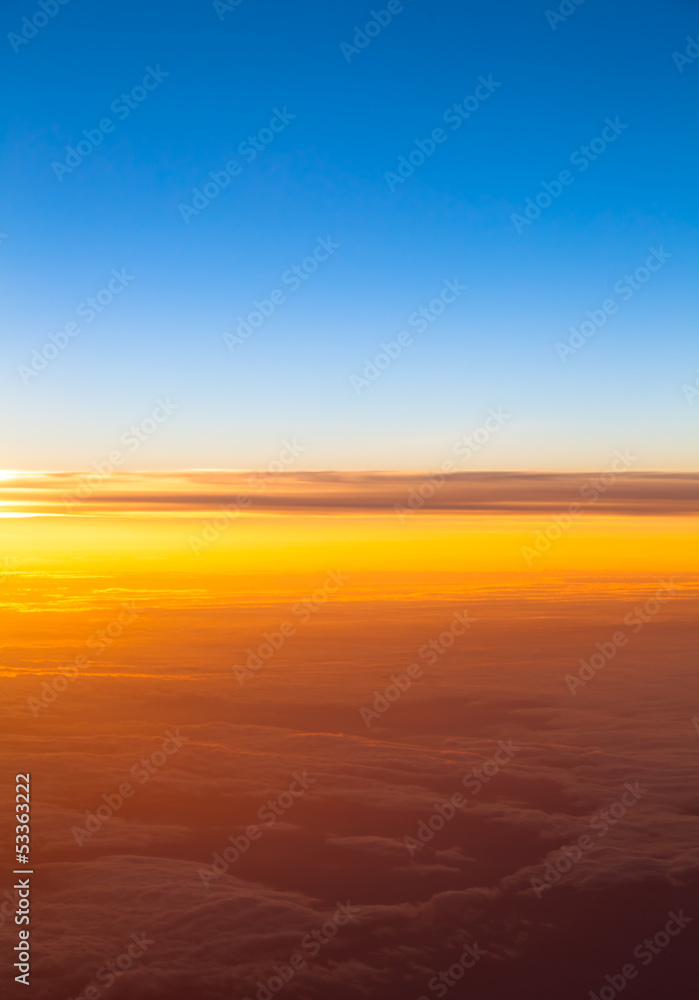 Dramatic sunset.  View of sunset above clouds from airplane wind