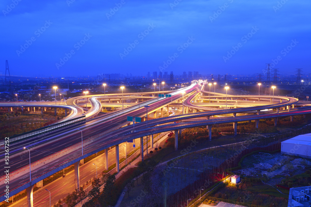 Fototapeta premium modern city with highway overpass in sunset night scene