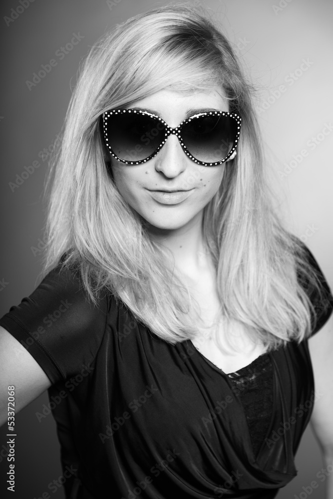 Beauty portrait of pretty girl with long blonde hair and sunglas Beauty portrait of pretty girl with long blonde hair and sunglas