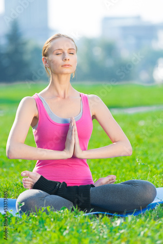 Woman doing stretching fitness exercise Yoga. lotus © mr.markin