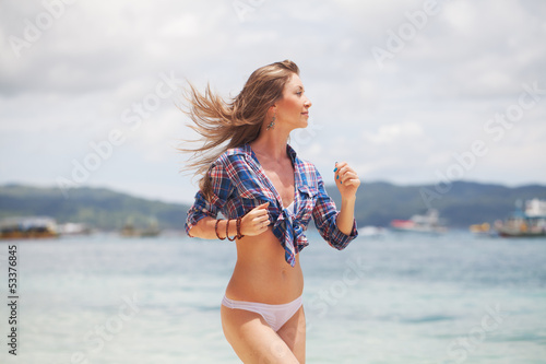 Running woman on the beach